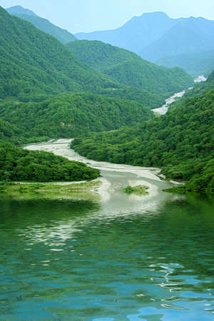 reflections mountain landscape in surfaces lakeの写真素材