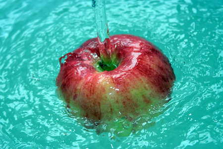 abstract scene red apple in current waterの写真素材
