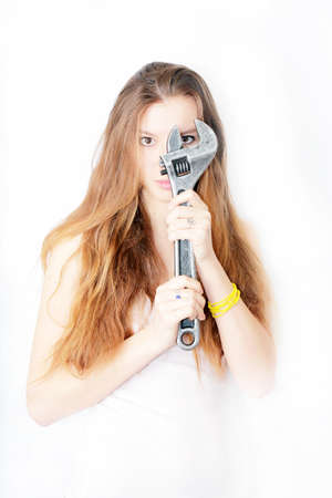 beautiful girl keeps in the hands wrench の写真素材