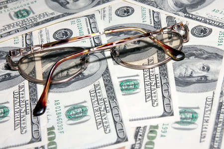 certain amount american dollars and old spectaclesの写真素材