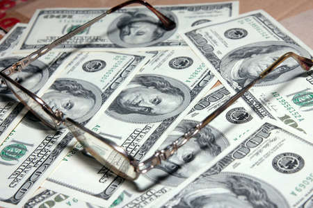 Certain amount american dollars and old spectaclesの写真素材