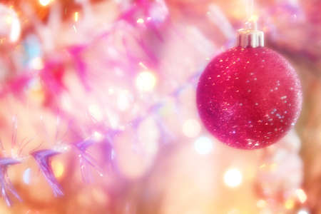 glow cristmas decoration on abstract varicoloured background の写真素材
