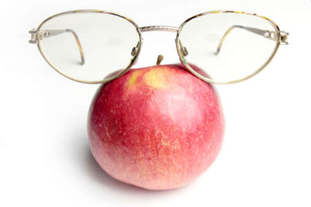 old spectacles and ripe fresh apple as symbol health feedingの写真素材