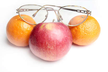 old spectacles and ripe fresh apple as symbol health feedingの写真素材
