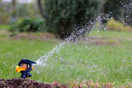 irrigation system moistening land for growing green lawnの写真素材