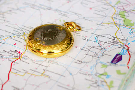 choice of route with the use old clock and geographical mapの写真素材