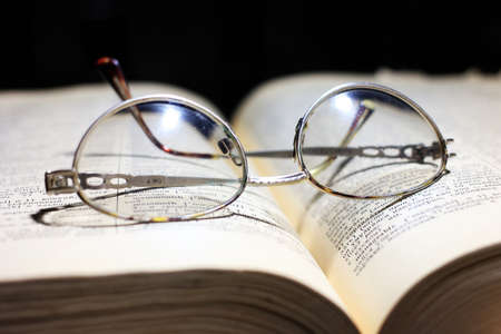 old book and glasses for the correction of sightの写真素材