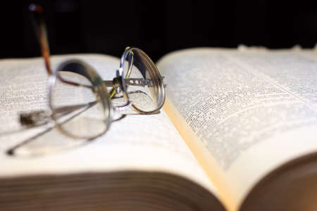 old book and glasses for the correction of sight