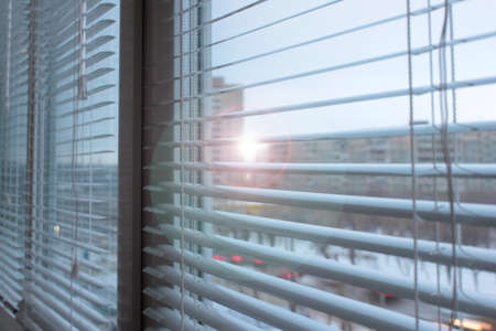 light plastic shutter on a window apartmentの写真素材