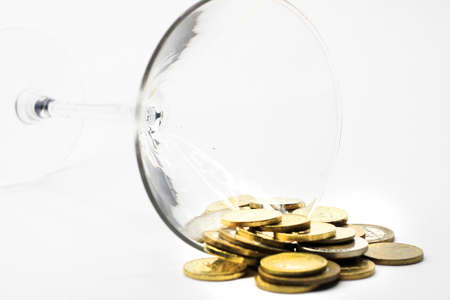 metallic coin and wineglass as an abstract pay system imageの写真素材