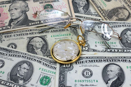 old spectacles, dollars and watch as element of the businessの写真素材