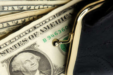 shallow paper dollars are in a black purseの写真素材