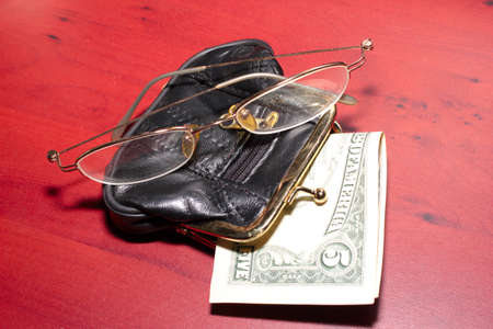 purse, glasses for a correction sight and paper note dollarの写真素材