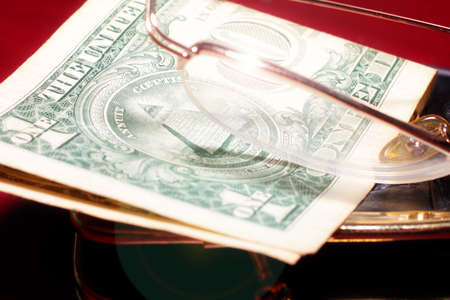 abstract purse, glasses for a correction sight and paper note dollar