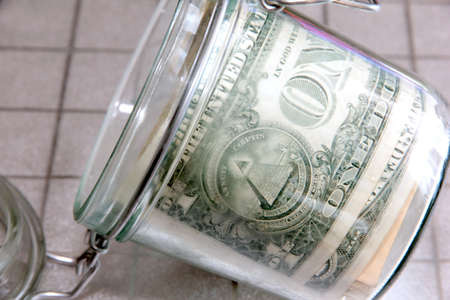 Small paper dollars in a plastic cash drawer