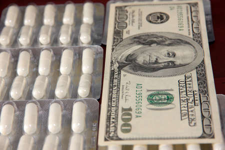 dollars and a bunch of packaged medical pills