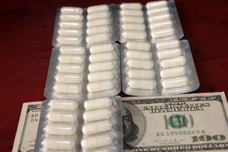dollars and a bunch of packaged medical pills