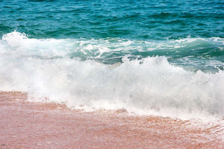 Sandy beach and the waves of the Mediterranean Seaの写真素材