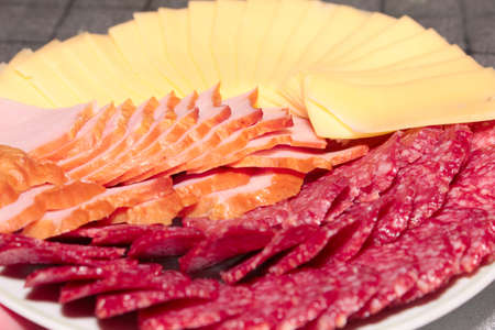 Pieces of sausage and cheese as an element of foodの写真素材