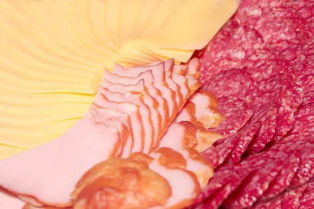 Pieces of sausage and cheese as an element of foodの写真素材