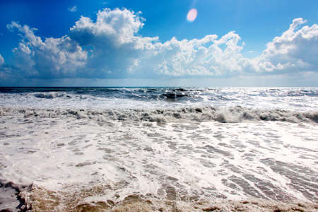 High wave in time gale on a sea and blue skyの写真素材