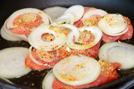 cooking dinner dish of meat and onion ringsの写真素材