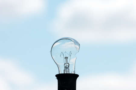 old broken electric bulb and skyの写真素材