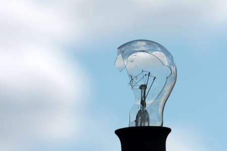 old broken electric bulb and skyの写真素材