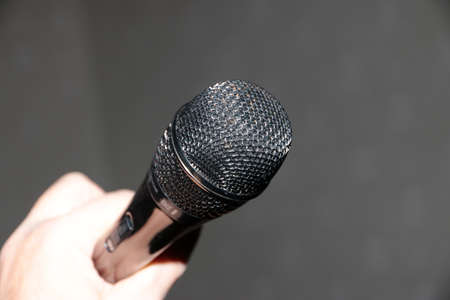 professional microphone in hand as a tool for sound recordingの写真素材