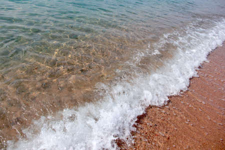 Low calm waves and sandy beach seaの写真素材