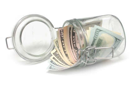 paper dollar notes in a glass jar accumulation