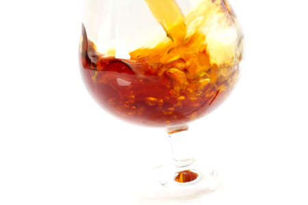 abstract patterns pours a drink into a glass of wine