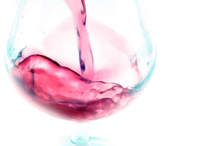 abstract patterns pours a drink into a glass of wine