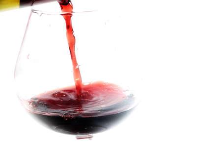 abstract patterns pours a drink into a glass of wineの写真素材
