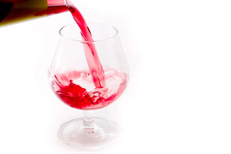 abstract patterns pours a drink into a glass of wineの写真素材