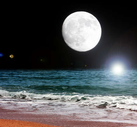 full moon and night sea beachの写真素材