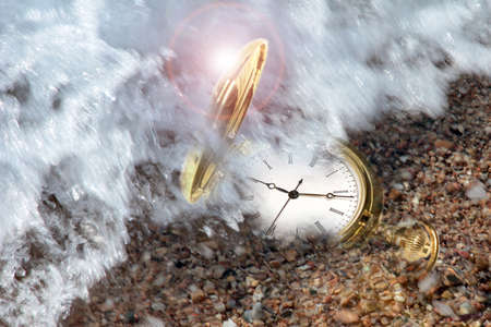 gold watch and sand of the sea on the coast