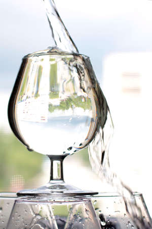 stream of pure water in a glassの写真素材