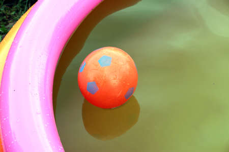 children's rubber ball and the water in the poolの写真素材