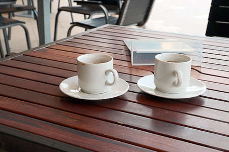 cup of black coffee on the wooden table outdoor cafの写真素材
