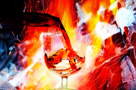 abstract image of a glass of wine and an open fireの写真素材