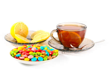 cup of hot tea with lemon and sweetsの写真素材