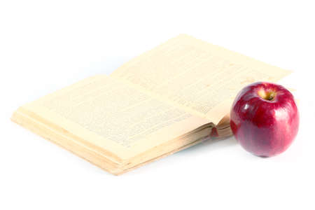 fine ripe red apple and old bookの写真素材