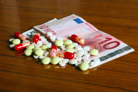 euro paper money and medical pills as part of paid treatmentの写真素材