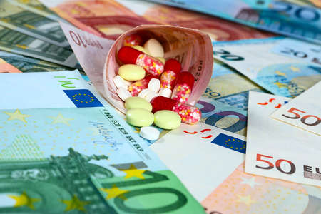 euro paper bills and medical pills and tabletsの写真素材