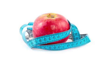 Red ripe fresh apple and measuring tape as part of a useful relationship to healthの写真素材