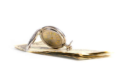 fine antique pocket watch in silver body and a small heap of paper dollarsの写真素材
