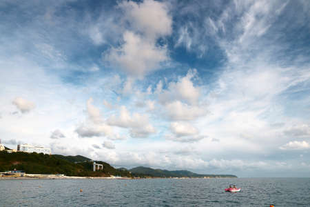 surface with waves and beautiful heavenly landscape with clouds and sunny skyのeditorial素材