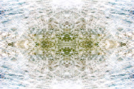 Symmetrical multicolored patterns on the surface of a cut of semi-precious stoneの写真素材