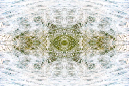 Symmetrical multicolored patterns on the surface of a cut of semi-precious stone